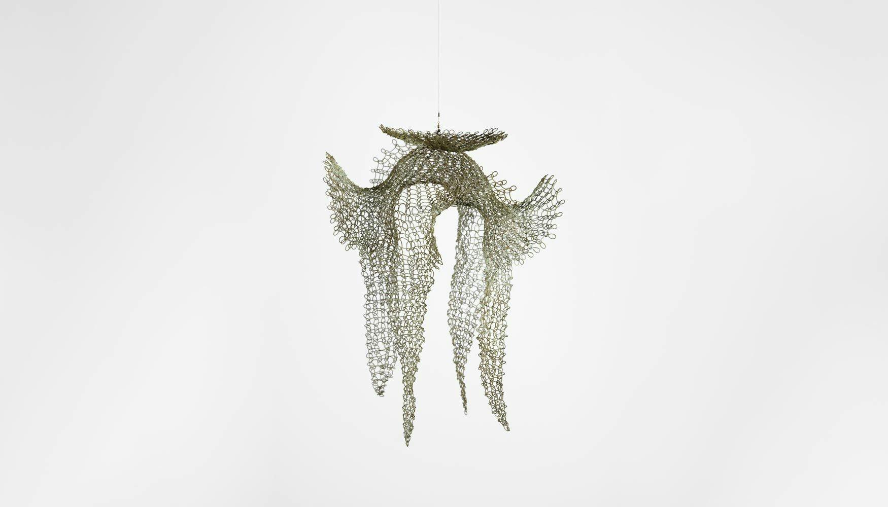 A mixed media artwork by Ruth Asawa, titled Untitled (S.459, Hanging Open Form with a Disc, Four Upward Ears, and Four Downward Tails), circa 1950 to 1959.